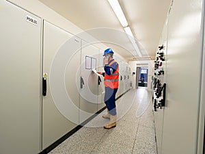 Industrial engineer using phone in machin control room