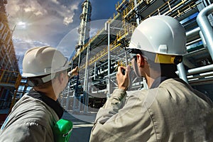 Industrial engineer or worker radio communication to the control room at oil and gas refinery plant form industry zone with