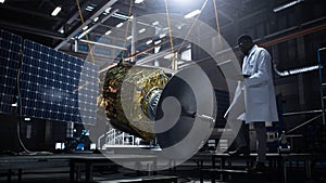 Industrial Engineer Working on Artificial Satellite Construction. Aerospace Agency: African American