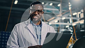 Industrial Engineer Working on Artificial Satellite Construction and Smiling on Camera. Aerospace