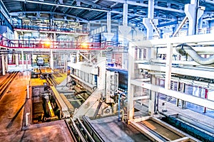 Industrial equipment at the factory in large production hall