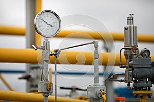 Industrial equipment pipes, manometer/pressure gauge, levers, faucets, indicators in a natural gas compressor station