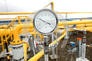 Industrial equipment pipes, manometer/pressure gauge, levers, faucets, indicators in a natural gas compressor station