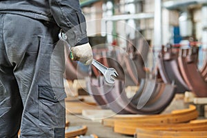 industrial equipment service and maintenance. worker with wrench in hand