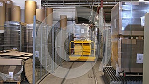 Industrial equipment - typical stretch wrapping machine in process of work. Packaging of corrugated cardboard. Selective focus