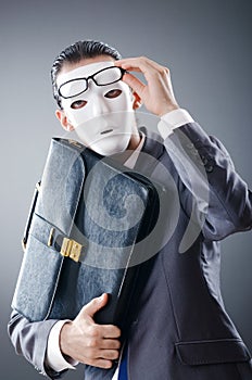 Industrial espionate concept - masked businessman