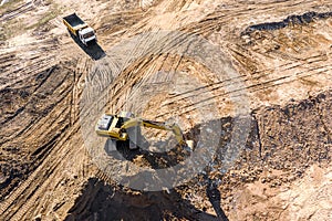 Industrial excavator and dump truck prepare ground for future construction works