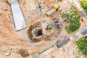 Industrial excavator and dump truck working at construction site