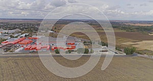 Industrial exterior of a modern factory. Modern factory top view, flying around a new modern factory in orange colors.