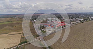 Industrial exterior of a modern factory. Modern factory top view, flying around a new modern factory in orange colors.