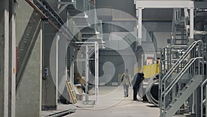 Industrial Facility Hallway. Workers in the hallway of an industrial manufacturing facility.