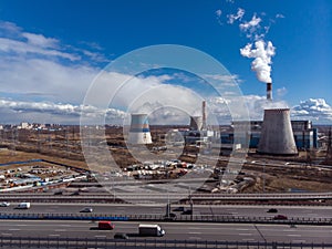 Industrial factory buildings and smoking chimney pipes. Combined heat and power station or thermal power plant scenery. Industry