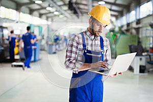Industrial factory employee working in metal manufacturing industry