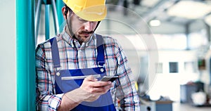 Industrial factory employee working in metal manufacturing industry