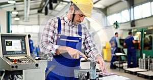 Industrial factory employee working in metal manufacturing industry