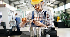 Industrial factory employee working in metal manufacturing industry