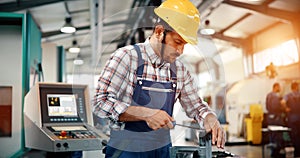 Industrial factory employee working in metal manufacturing industry