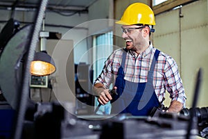 Industrial factory employee working in metal manufacturing industry.