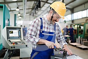 Industrial factory employee working in metal manufacturing industry