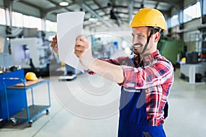 Industrial factory employee working in metal manufacturing industry