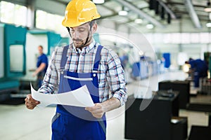 Industrial factory employee working in metal manufacturing industry