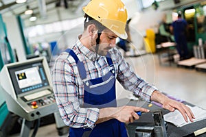 Industrial factory employee working in metal manufacturing industry