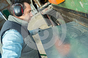 Industrial factory employee working in metal manufacturing industry