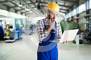 Industrial factory employee working in metal manufacturing industry