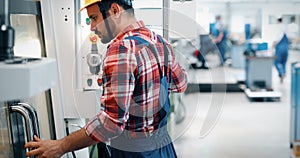 Industrial factory employee working in metal manufacturing industry