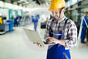 Industrial factory employee working in metal manufacturing industry