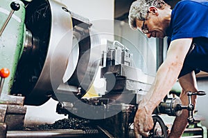 Industrial factory employee working in metal manufacturing industry photo