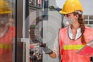 Industrial or factory engineering worker and supervisor setting up computerized control panel of factory assembly line controller photo