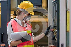 Industrial or factory engineering worker and supervisor setting up computerized control panel of factory assembly line controller