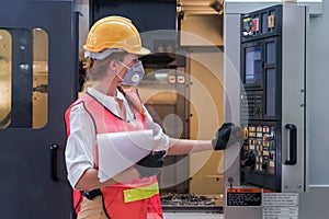 Industrial or factory engineering worker and supervisor setting up computerized control panel of factory assembly line controller