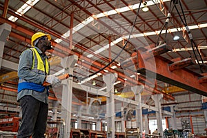 Industrial factory and manufacturing concept. Worker working with crane