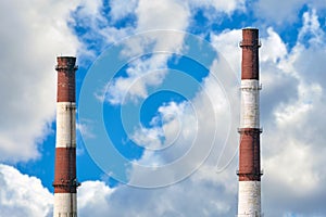 Industrial factory pipes against a blue sky