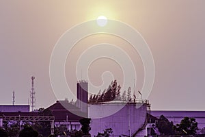 Industrial factory plant with sunset sky clouds for use in industry concept