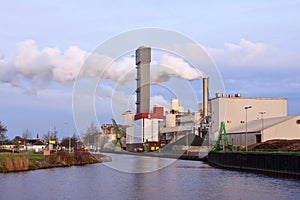 Industrial factory with smoking chimney
