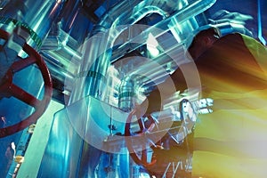 Industrial factory worker turning red wheel of valve