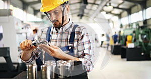 Industrial factory employee working in metal manufacturing industry