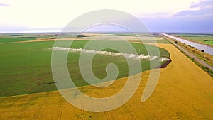 Industrial farming. Aerial video footage: irrigation of a lettuce field in Europe in Summer. Watering and irrigating