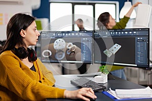 Industrial female engineer using on computer showing CAD software