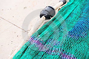 Industrial Fishing Equipment Fishnets and Fishing Lines lying on concrete in the port