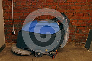 Industrial floor washing machine stands in a shopping mall