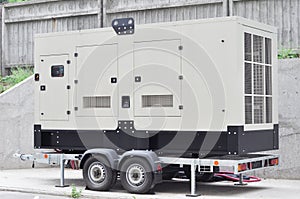 Industrial generator power. Mobile diesel backup generator on caravan wheels.  Backup power supply generator for emergency
