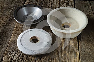 Industrial grinding and polishing wheels on a wooden table