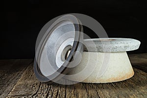 Industrial grinding and polishing wheels on a wooden table