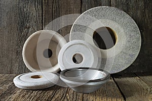 Industrial grinding and polishing wheels on a wooden table