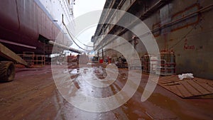 Industrial harbor ship in drydock, view on ship port and cranes