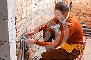 industrial heat engineer worker plumber at boiler room installation.